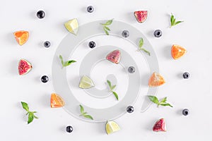 Cut fruit pattern with mint on white desk background top view