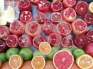 Cut fruits including apple, pomegranate and oranges at stall
