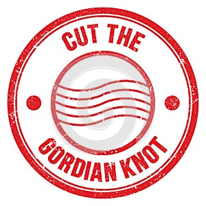 CUT THE GORDIAN KNOT text on red round postal stamp sign