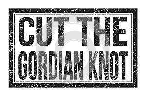 CUT THE GORDIAN KNOT, words on black rectangle stamp sign