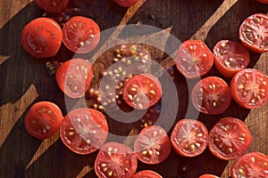 Cut grape tomatoes on wood cutting board
