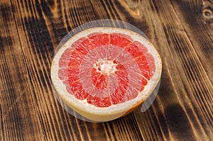 Cut grapefruit half on wooden table