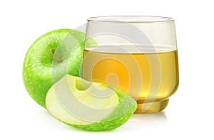 Cut green apples and apple juice in a glass over white background