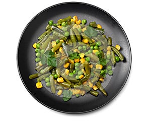 Cut green beans, green peas and corn at black plate isolated on white background. top view. healthy food