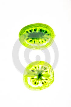 Cut green tomato on a white background