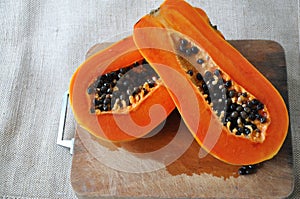 Fresh Papaya on Wooden Board Background