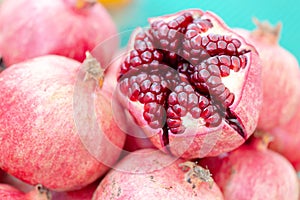Cut in half, peeled pomegranate with bold seeds on market stall