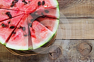 Cut in half watermelon on old wooden table. Red ripe fruit wood background top view image