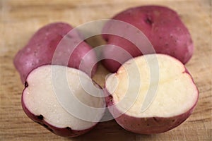 Cut in halves raw potatoes on flat surface