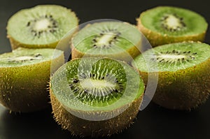 cut kiwi against black background/cut kiwi against black background. selective focus