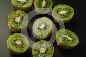 cut kiwi against black background/cut kiwi against black background. Top view