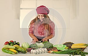 cut with knife. Child and vegetables. Healthy eating and lifestyle concept. Green vegetarian food. girl with variety of