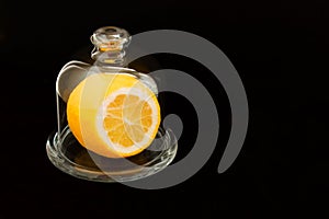 Cut lemon in glassware on black backgroundCopy space