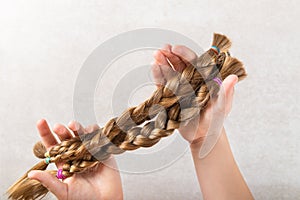 Cut long hair as donation for cancer charity