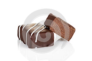 Cut luxury handmade candy with chocolate ganache on white background