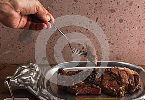 Cut of meat `Aguja norteÃÂ±a Sonora`, served on a silver plate in the shape of a cow 10 photo