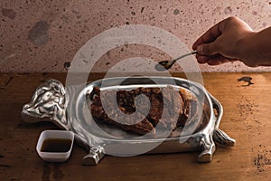 Cut of meat `Aguja norteÃÂ±a Sonora`, served on a silver plate in the shape of a cow 15 photo