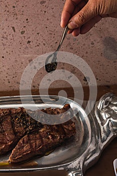 Cut of meat `Aguja norteÃÂ±a Sonora`, served on a silver plate in the shape of a cow 12 photo