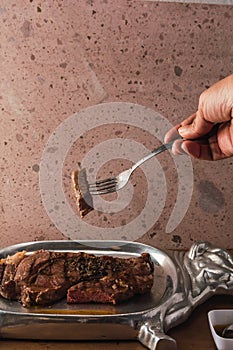 Cut of meat `Aguja norteÃÂ±a Sonora`, served on a silver plate in the shape of a cow 9 photo