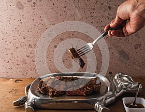 Cut of meat `Aguja norteÃÂ±a Sonora`, served on a silver plate in the shape of a cow 6 photo