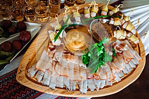 Cut meat lies on the original wooden dishes