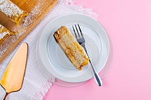 Cut off piece of apple pie on a white plate. Delicious apple pie or apple cake with fresh apples and spices. Cake arrangement