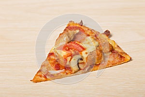 Cut off slice pizza on wood
