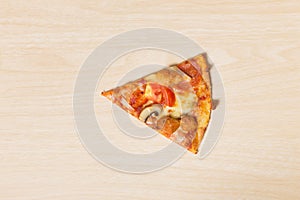 Cut off slice pizza on wood