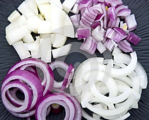 Cut onions on a black plate