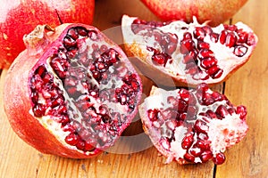 Cut open pomegranate on wooden cutting board