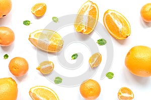 Cut oranges for juicy breakfast on white background top view pattern