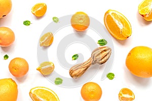 Cut oranges for juicy breakfast on white background top view pattern