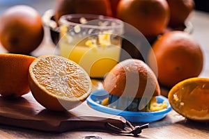 Cut oranges. Pressed orange manual method. Oranges and sliced oranges with juice and squeezer.