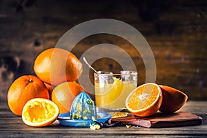 Cut oranges. Pressed orange manual method. Oranges and sliced oranges with juice and squeezer.