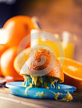 Cut oranges. Pressed orange manual method. Oranges and sliced oranges with juice and squeezer.