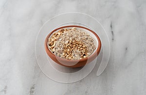 Cut orris root in a bowl on a marble counter top