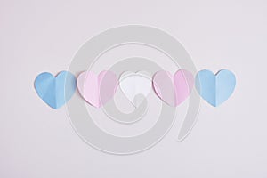 cut out colored paper hearts on gray background, transexual colors, lgbt pride concept