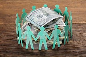 Cut-out Figures Around The Hundred Dollar Bill