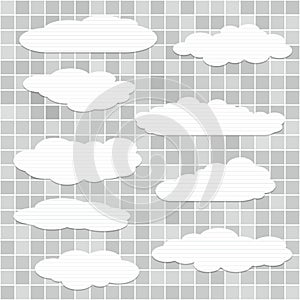 Cut out lined paper clouds are stuck on gray squared pattern or wall