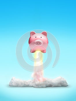 Cut-out object shot of a piggy bank rocket launch isolated on a blue background