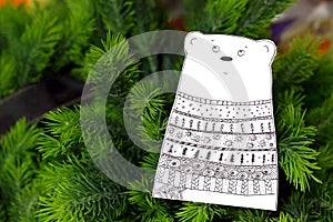 Cut out of paper bear figurine painted with patterns in doodling style. Paper figure bears