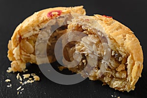 a cut out traditional chinese snack of sweet cake with melon seeds and almond nuts
