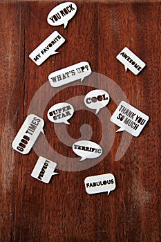 Cut out words and expressions on wood background