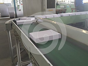 Cut pack paper packing machine running,. A4 sized white copier or xerox papers are being cut, stacked , counted and then being