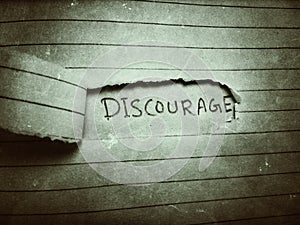 cut paper the word discouraged appeared on the next page written by pencil photo