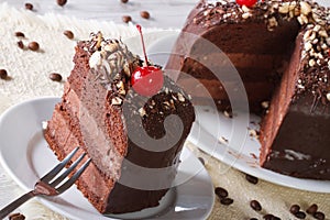 Cut a piece of dark chocolate cake with cherry horizontal