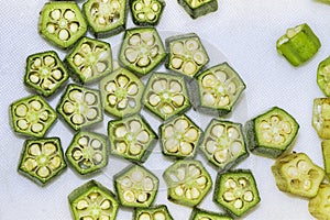 Cut pieced Fresh summer vegetable okra or Ladies finger on white background.