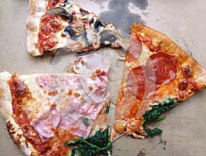 Cut pieces of Quatro Stagioni pizza in cardboard box. photo