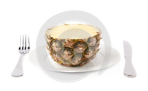 Cut pineapple on plate isolated over white background