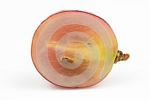 A cut pink grape berry isolated on a white background